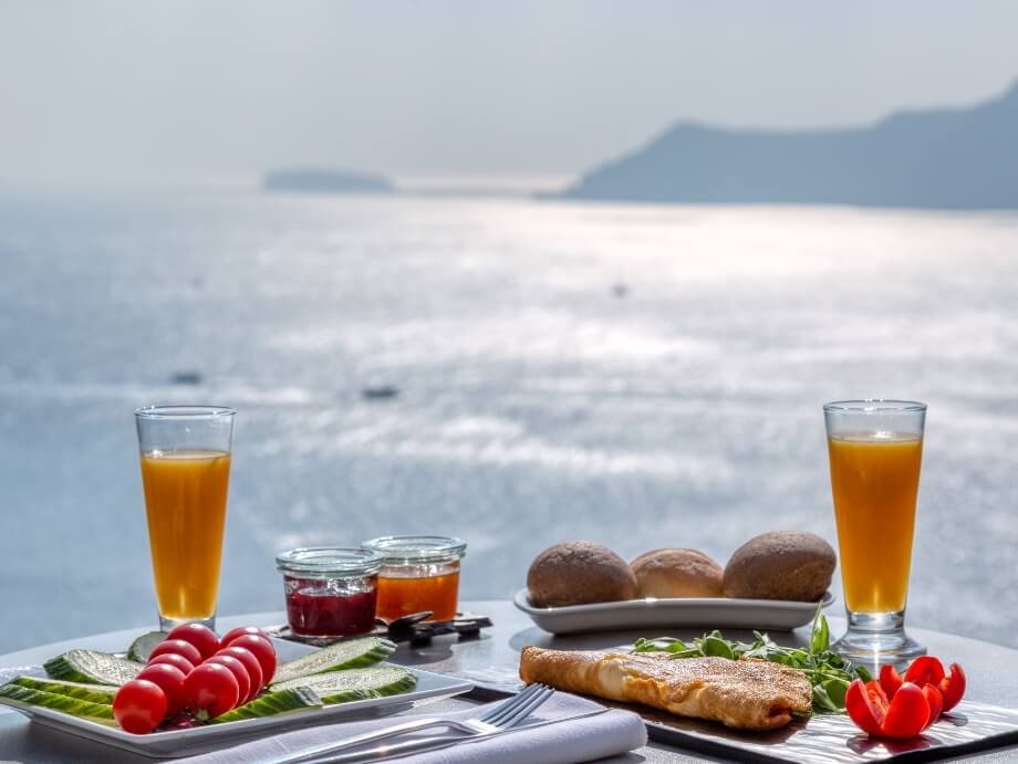 Delicious meal with a spectacular view of the volcano from Nostos Apartments in Oia Santorini