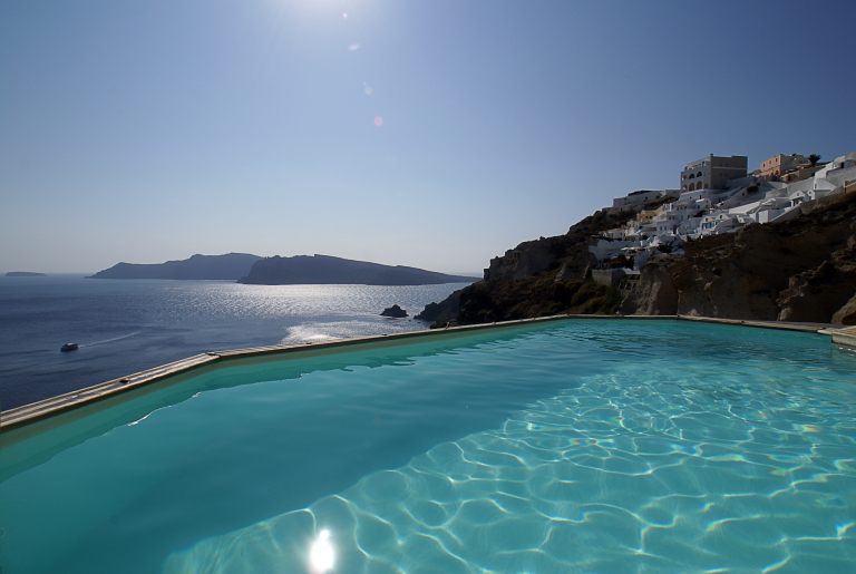 The magnificent view from the outdoor pool of the luxury Nostos Apartments in Oia Santorini