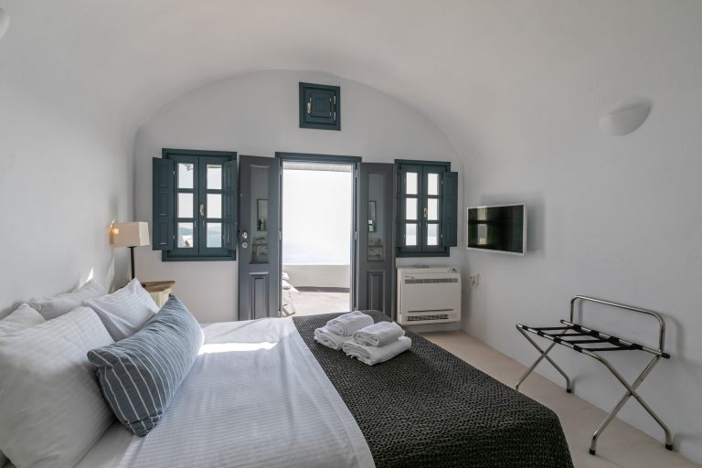 The comfortable double bed of the luxury apartment of Nostos Apartments in Oia Santorini